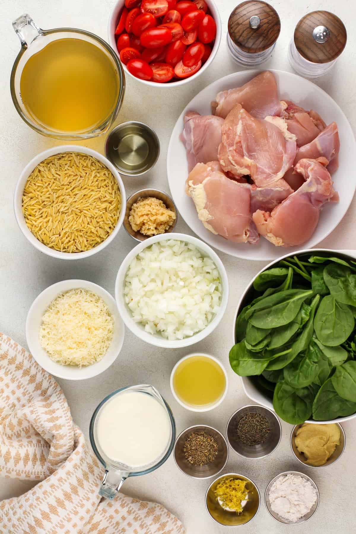 Ingredients for lemon chicken and orzo on a countertop.