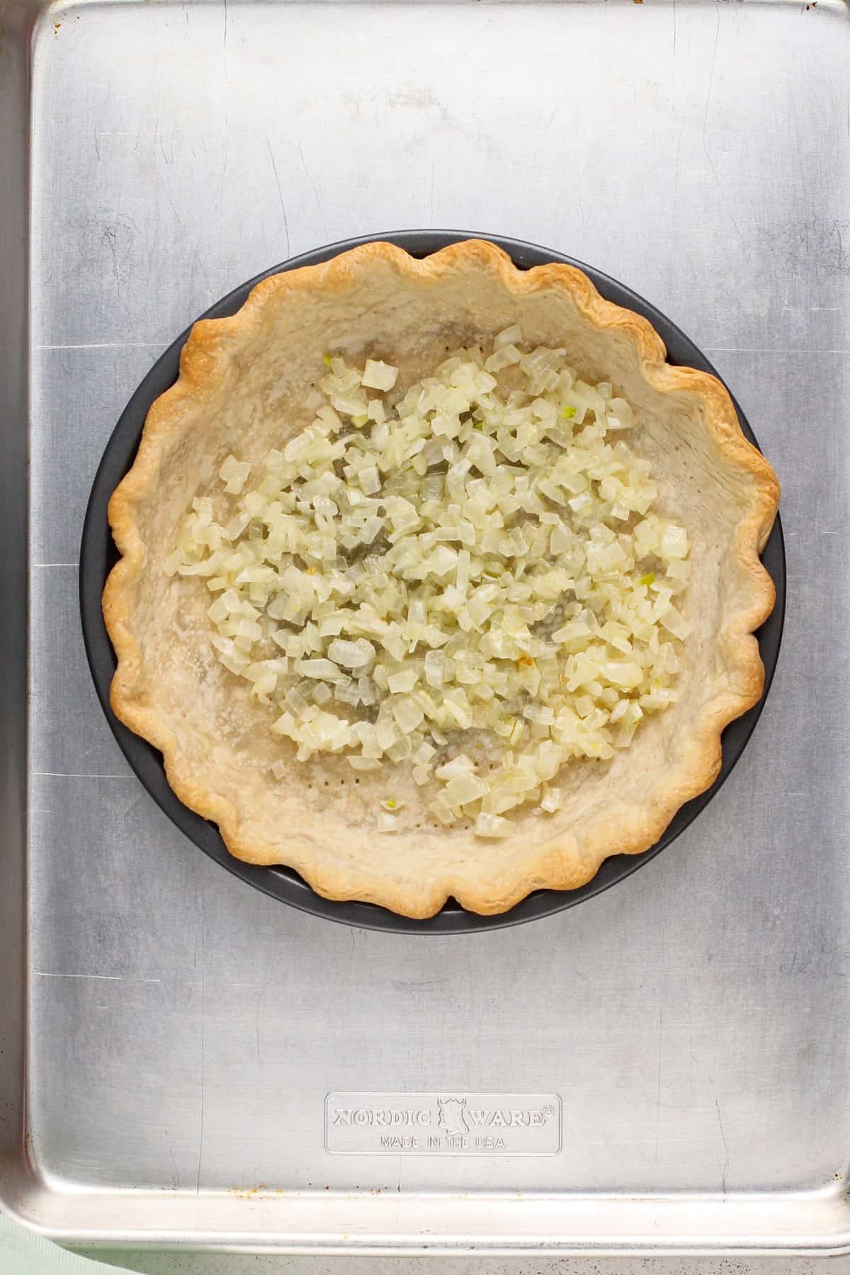 Sauted onions in a blind baked pie crust.