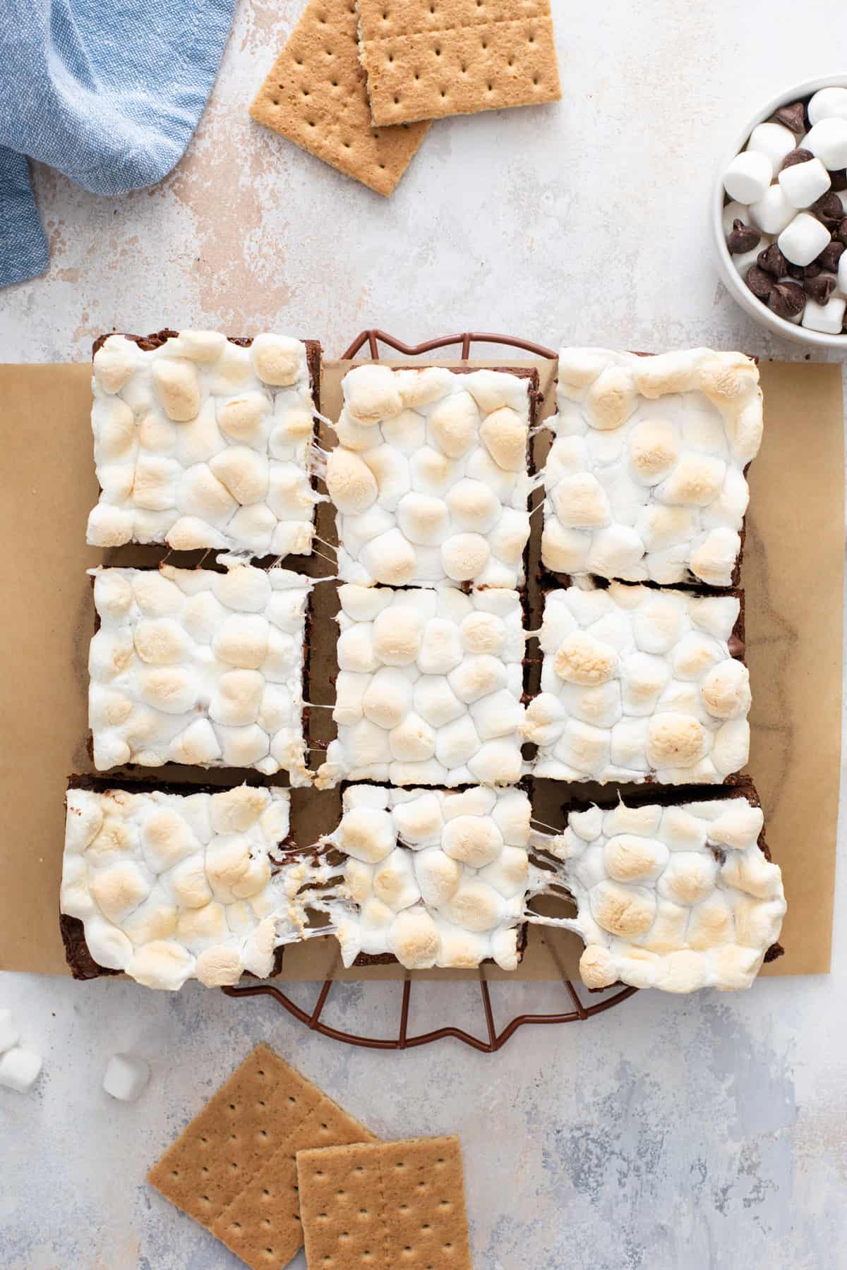Overhead view of sliced pan of easy s'mores brownies on a piece of parchment paper.