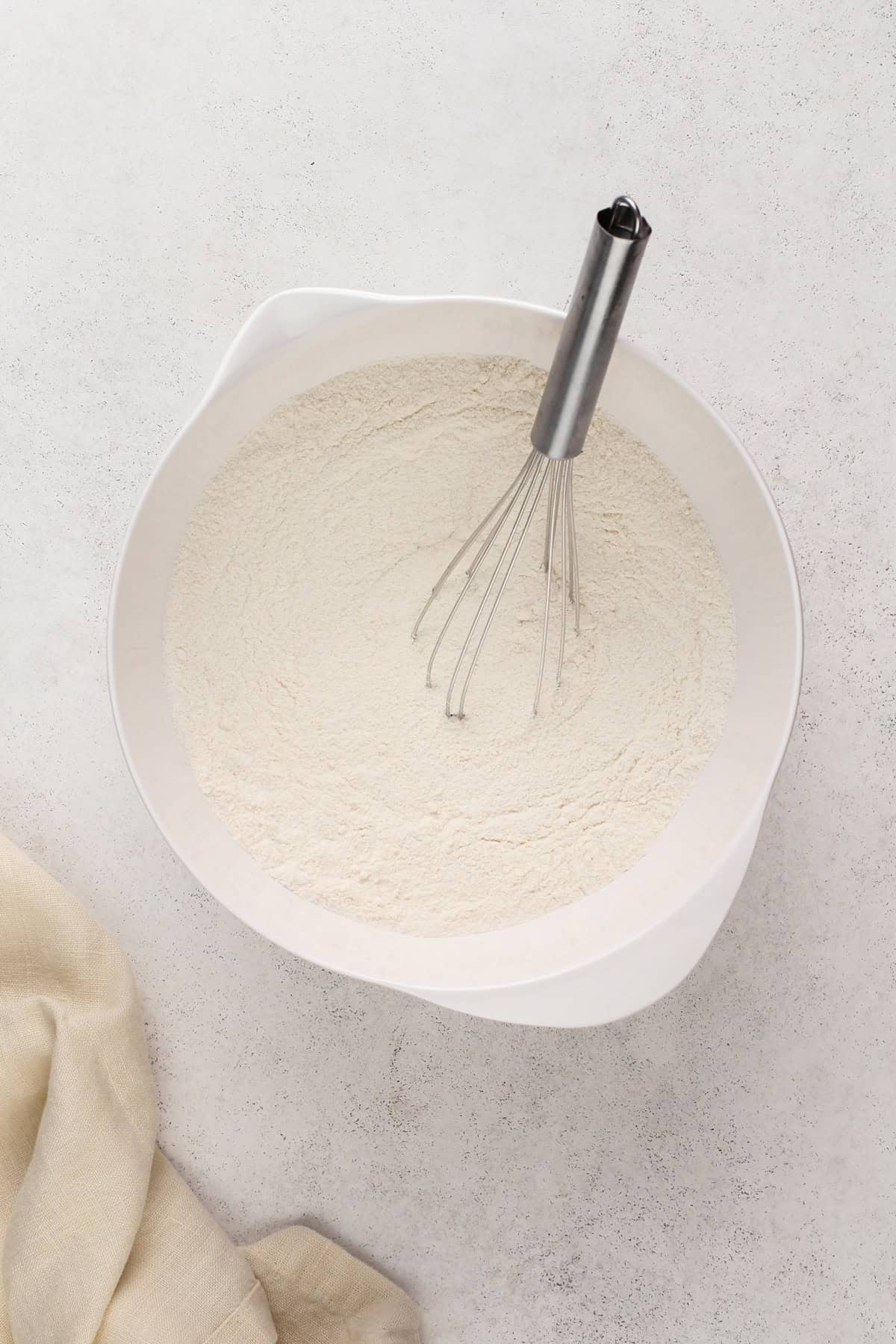 Dry ingredients for texas sheet cake in a white bowl.