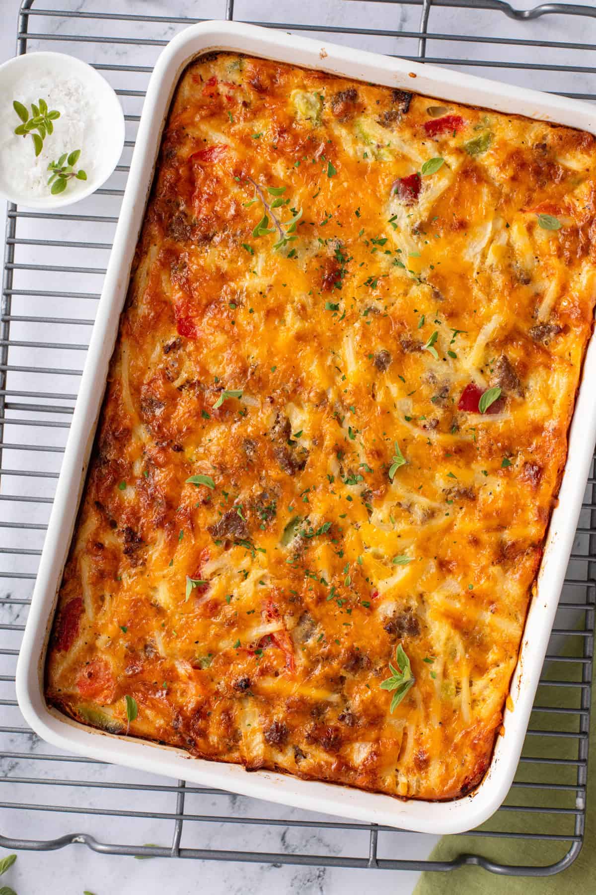 Overhead view of baked bisquick breakfast casserole in a white baking dish.