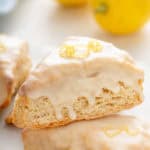 Close up of glazed lemon scone garnished with lemon zest.