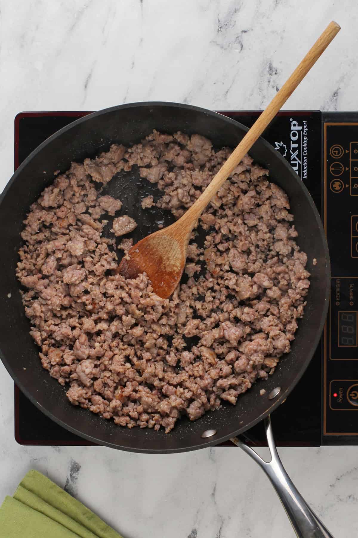 Cooked breakfast sausage in a black skillet.