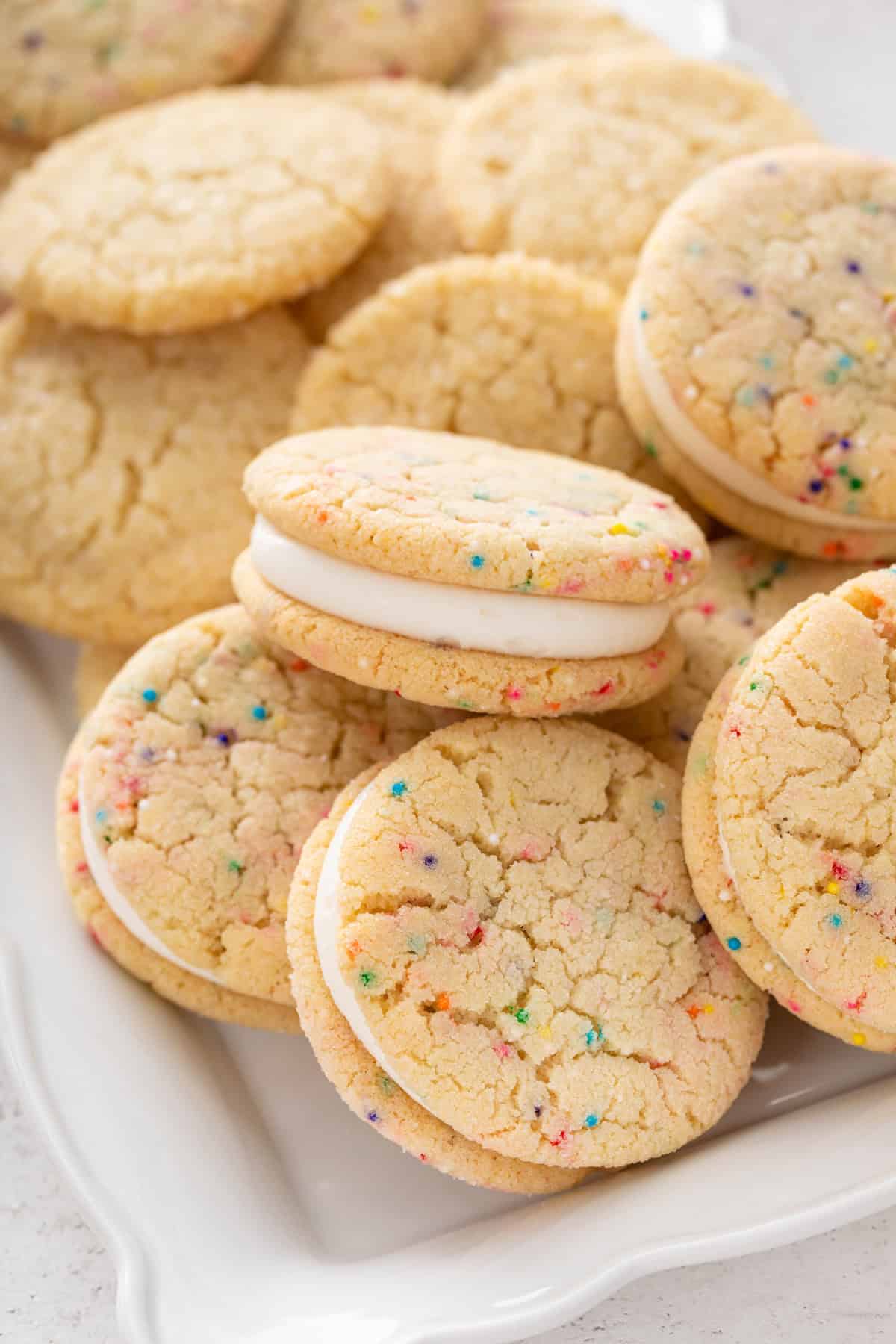 Close up of easy sugar cookie sandwiches on a white platter.