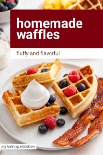 Dollop of whipped cream and fresh berries on a homemade waffle set next to bacon on a plate. Text overlay includes recipe name.