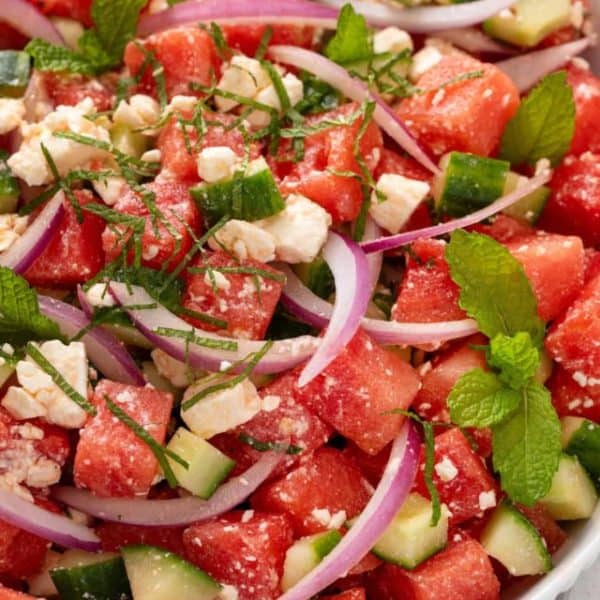 Close up of watermelon feta salad in a white bowl.