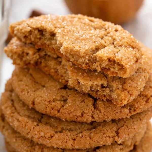 Halved brown sugar cookie on top of a stack of cookies.