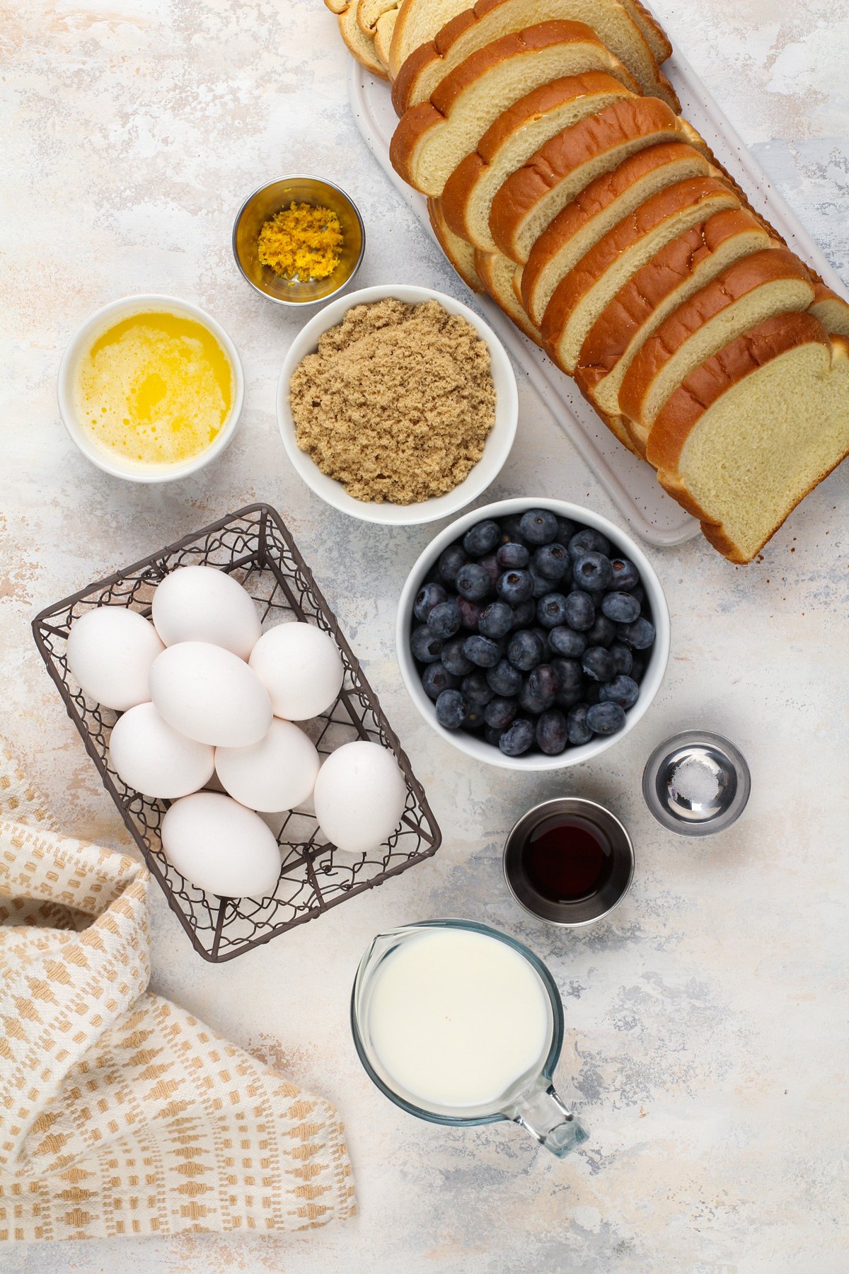 Blueberry french toast casserole ingredients arranged on a countertop.