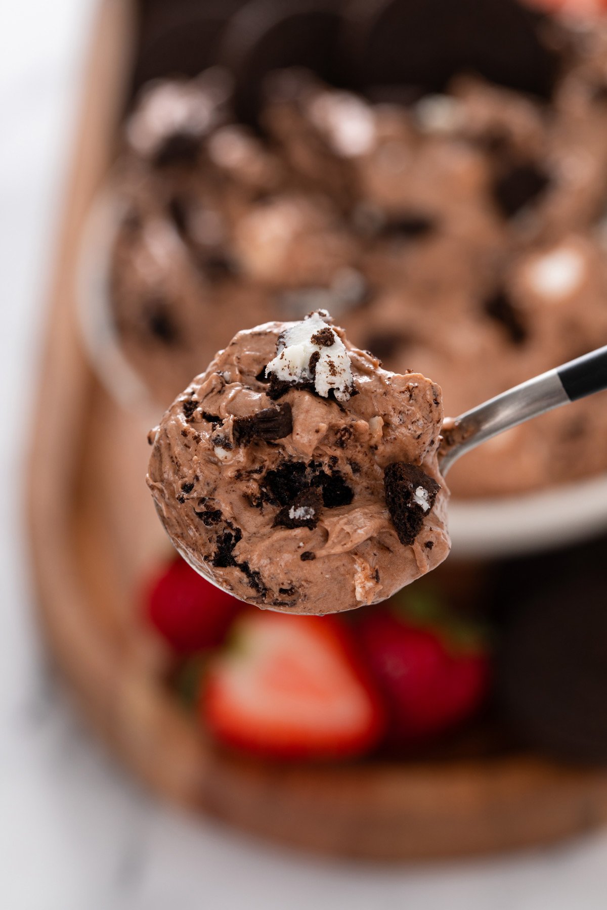 Spoon holding up a bite of oreo fluff to the camera.