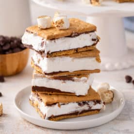 Stack of frozen s'mores on a white plate.