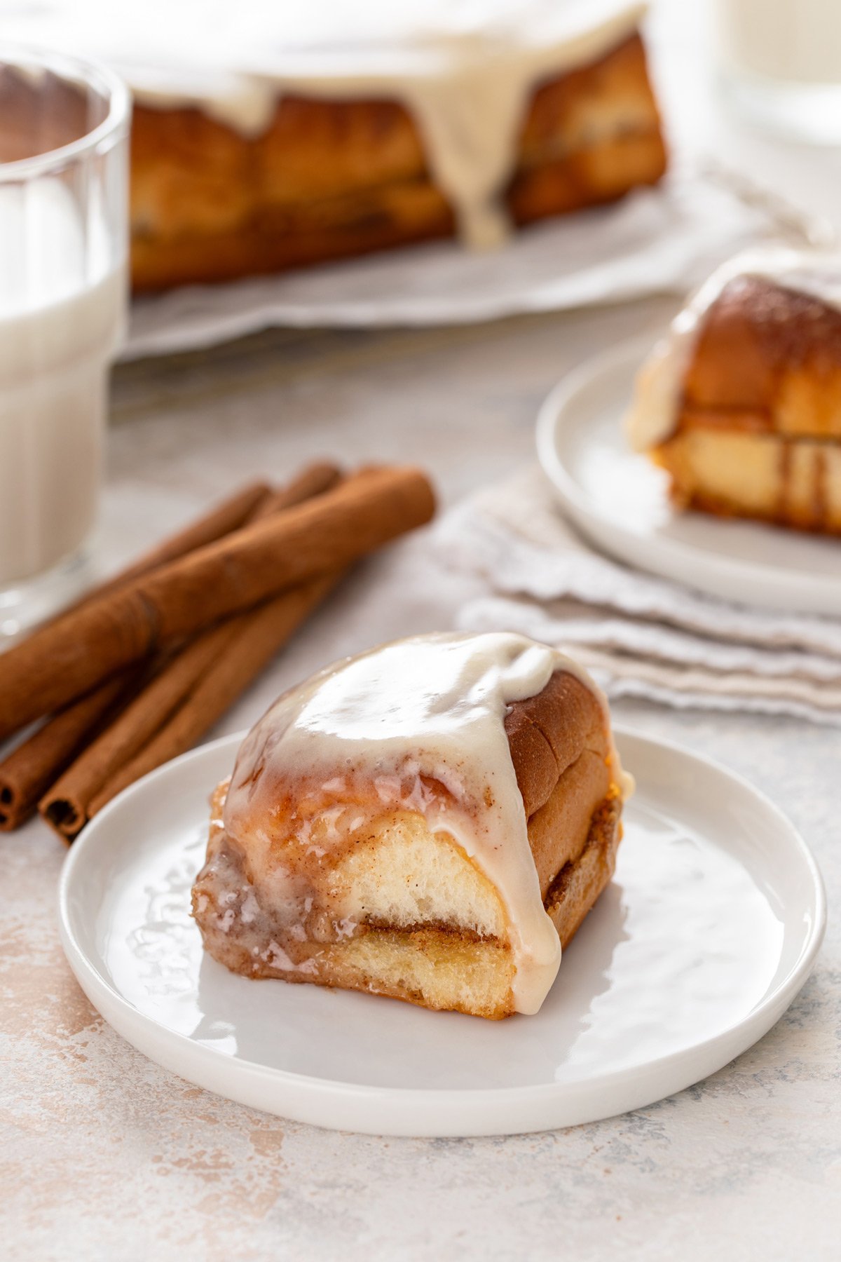Hawaiian roll cinnamon roll on a white plate.
