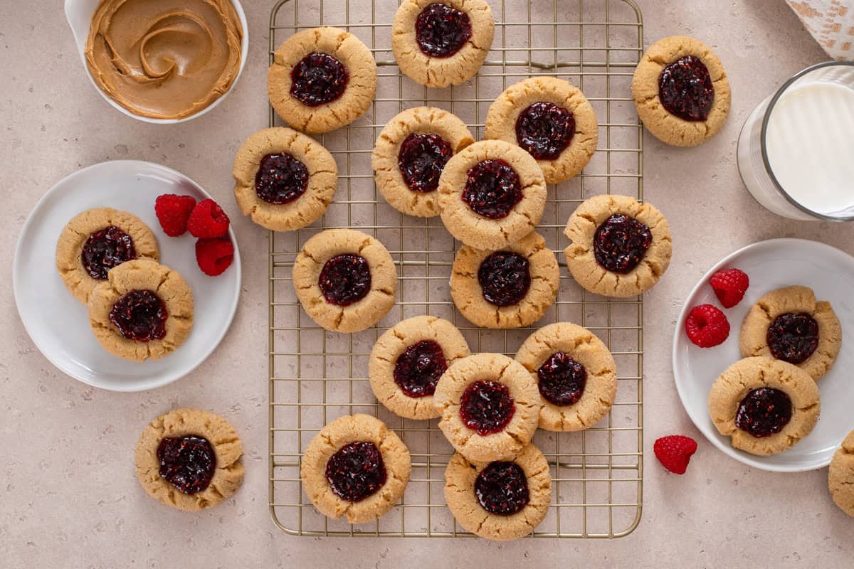 Overhead view of peanut butter and jelly cookies cooling on a wire rack.