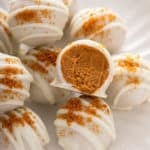 Close up of halved pumpkin cheesecake bite.