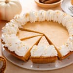 Sliced No-Bake Pumpkin Cheesecake Pie on a white platter.