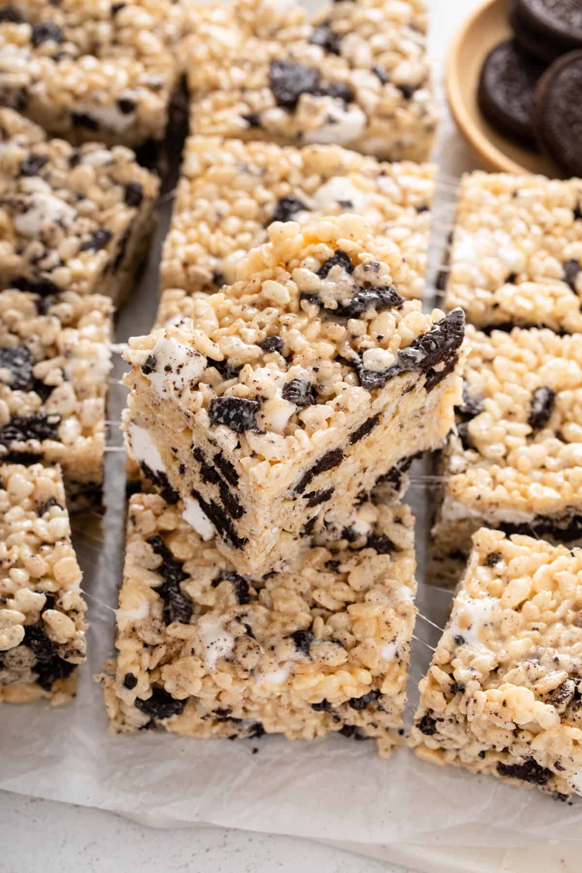 Oreo rice krispie treats stacked on top of more of the treats.