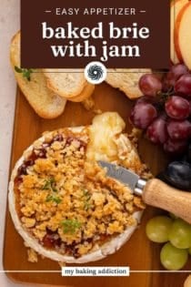 Overhead view of a cheese knife cutting into baked brie with jam. Text overlay includes recipe name.
