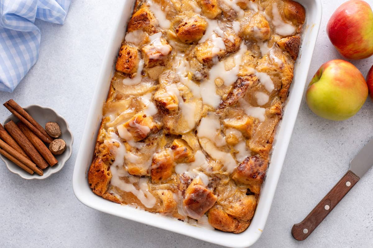 Finished cinnamon roll casserole in a white baking dish.
