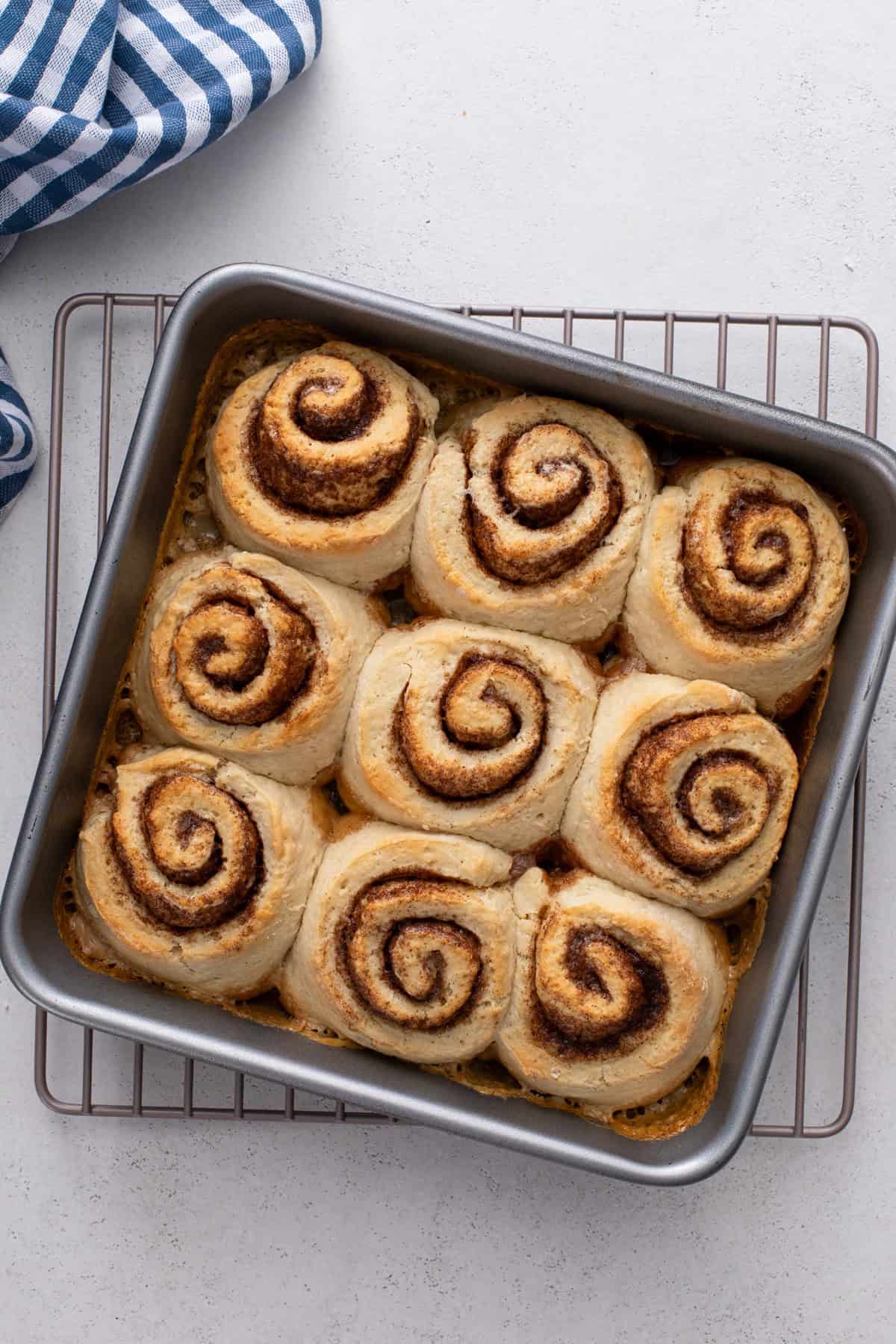 Baked biscuit cinnamon rolls cooling on a wire rack.