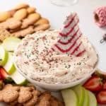 Christmas tree dip in a bowl, decorated with sprinkles and a christmas tree cake.