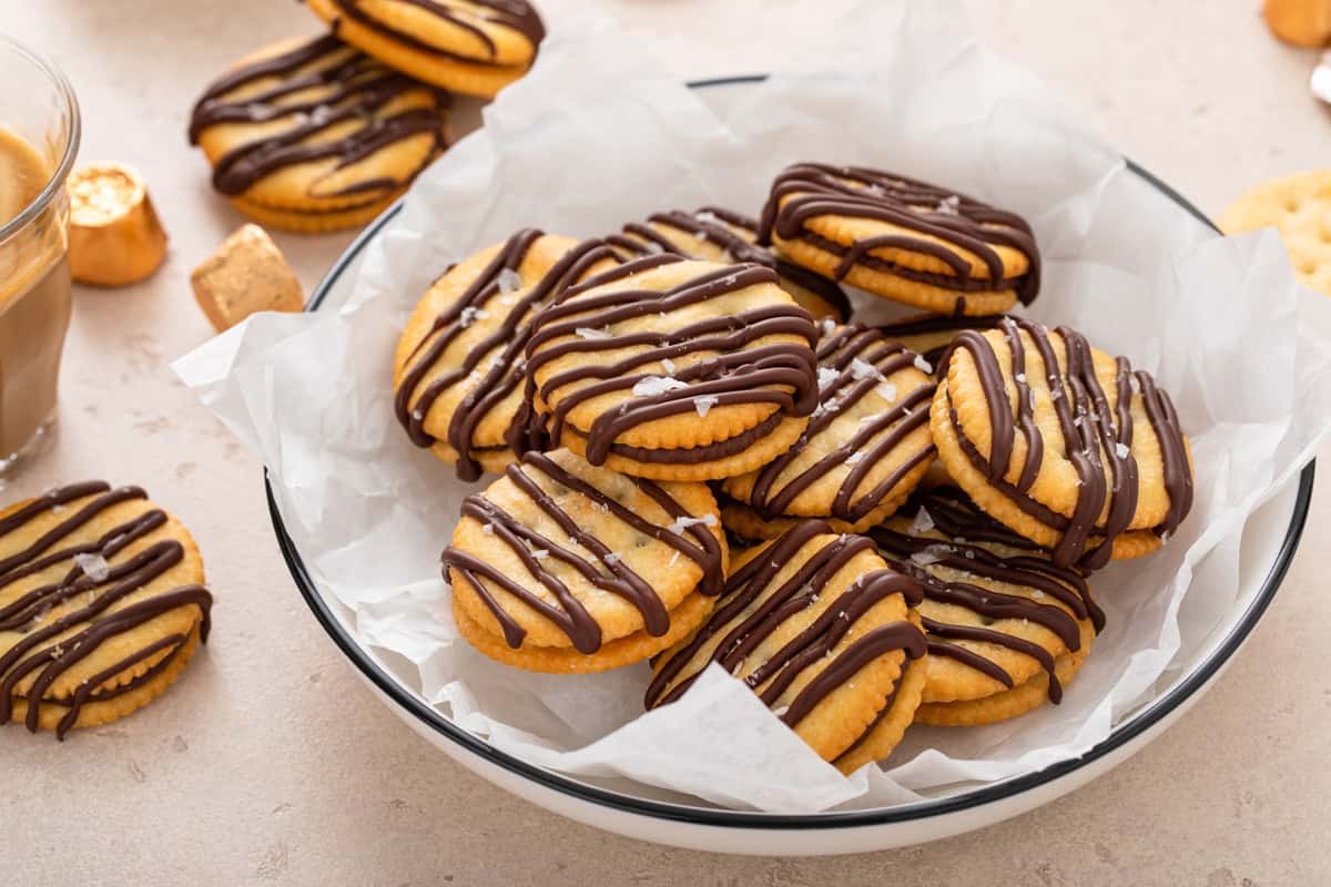 Rolo ritz cracker cookies arranged in a parchment-lined bowl.