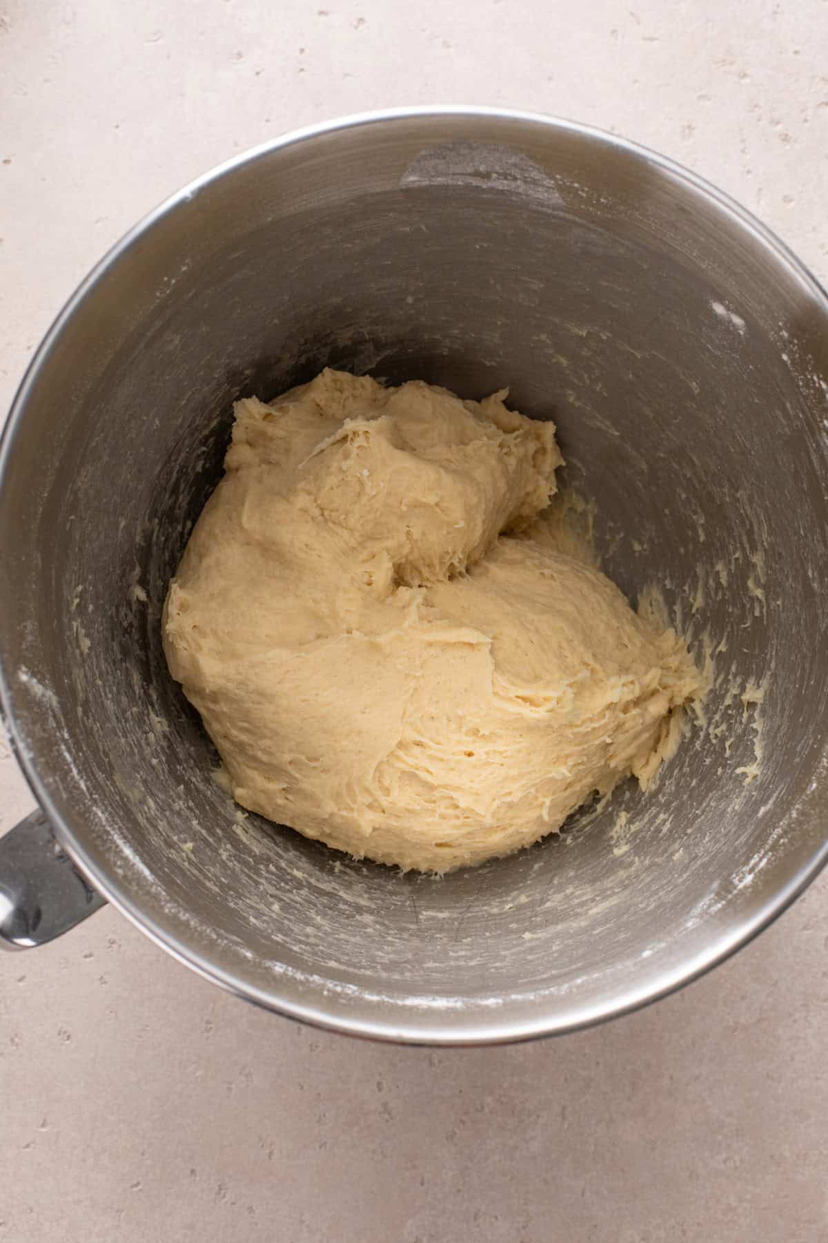 Mixed dough for potato bread in a stainless steel bowl.