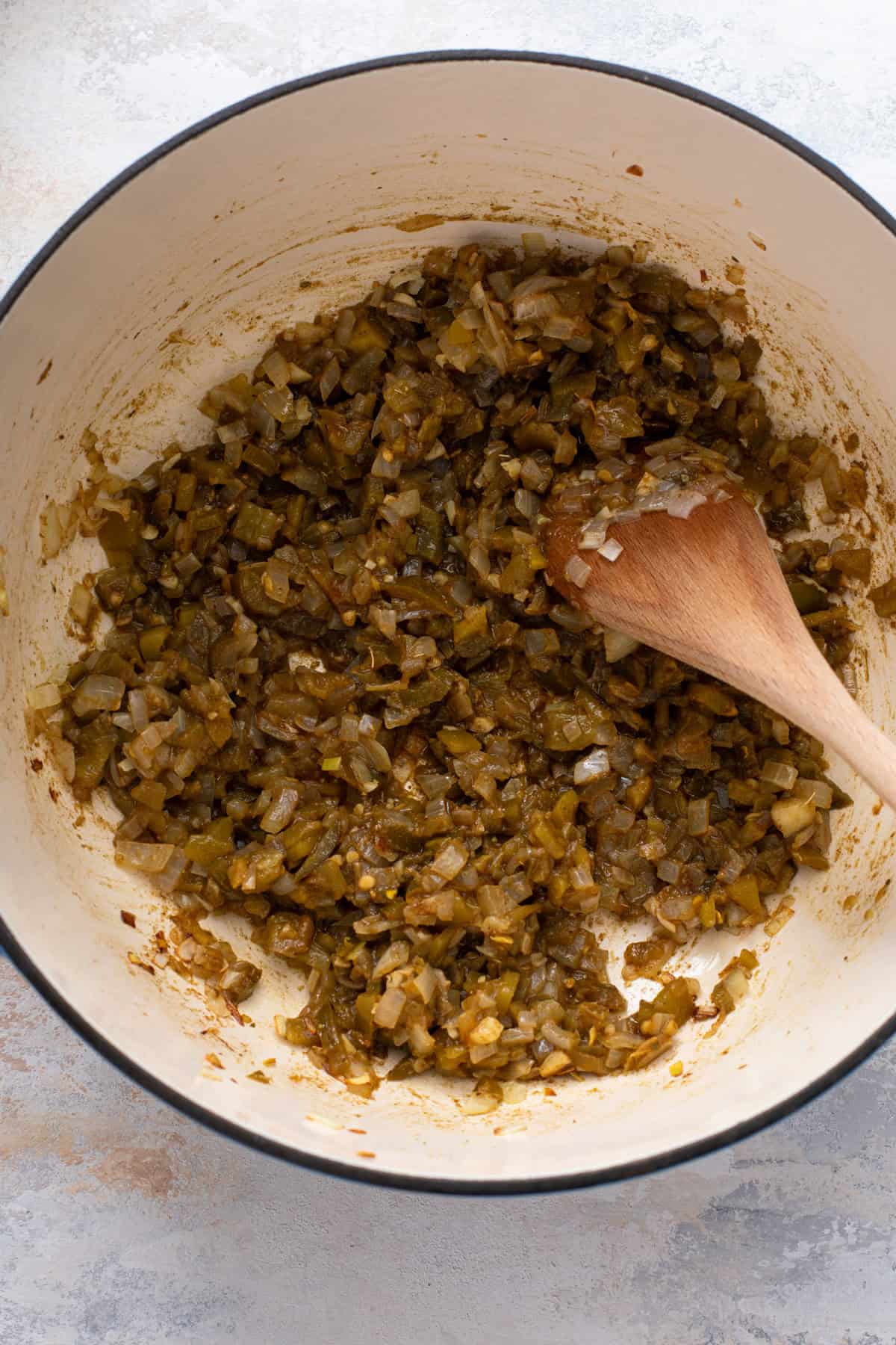 Green chiles, spices, and sauteed onions in a dutch oven.