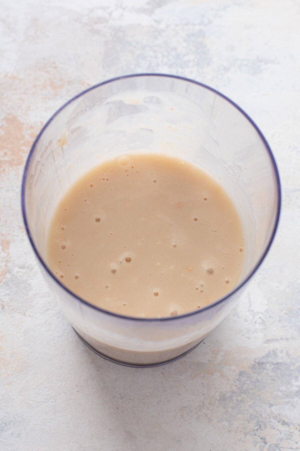 Pureed white beans in a blender cup.