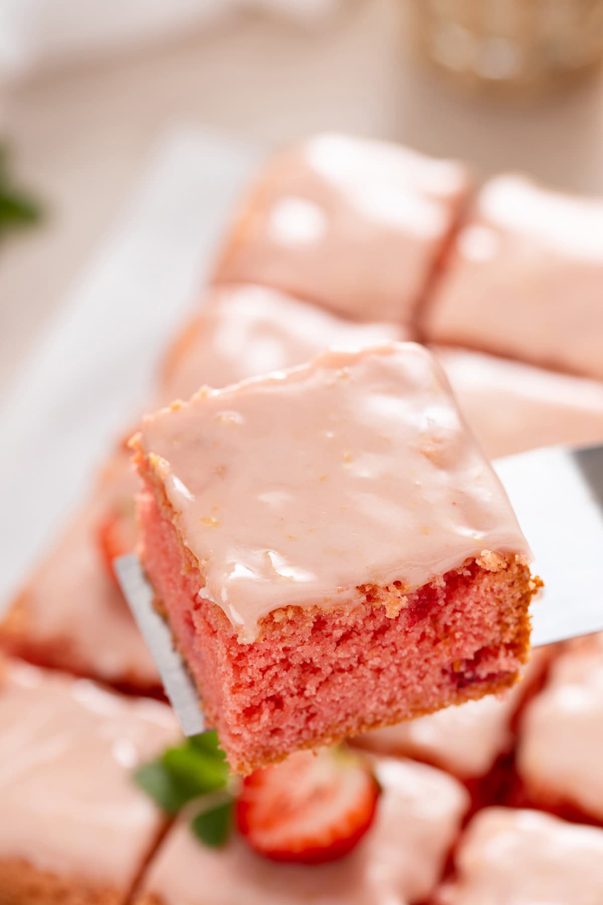 Cake server lifting up a sliced strawberry brownie.