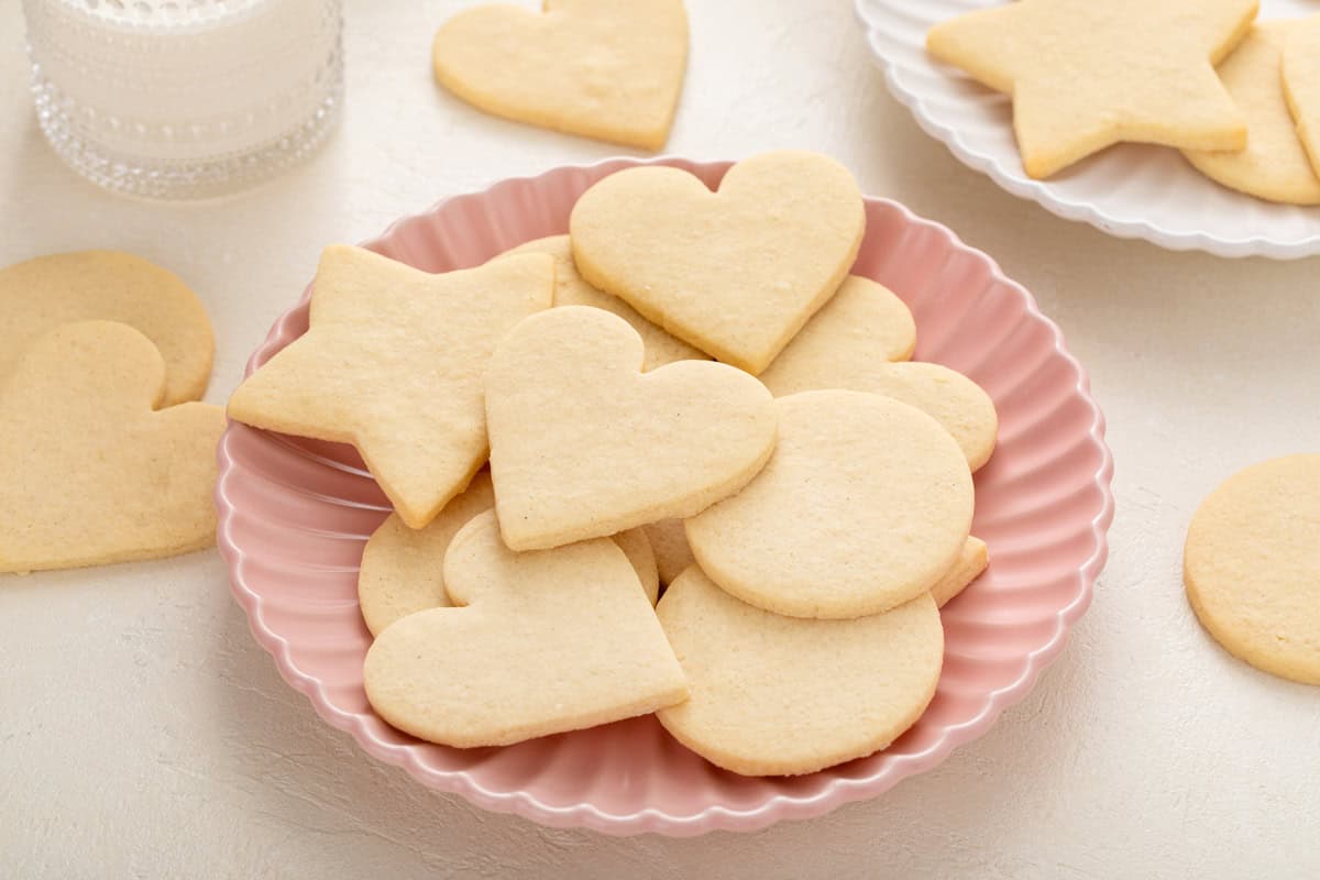 No-spread sugar cookies in assorted shapes arranged on a pink plate.
