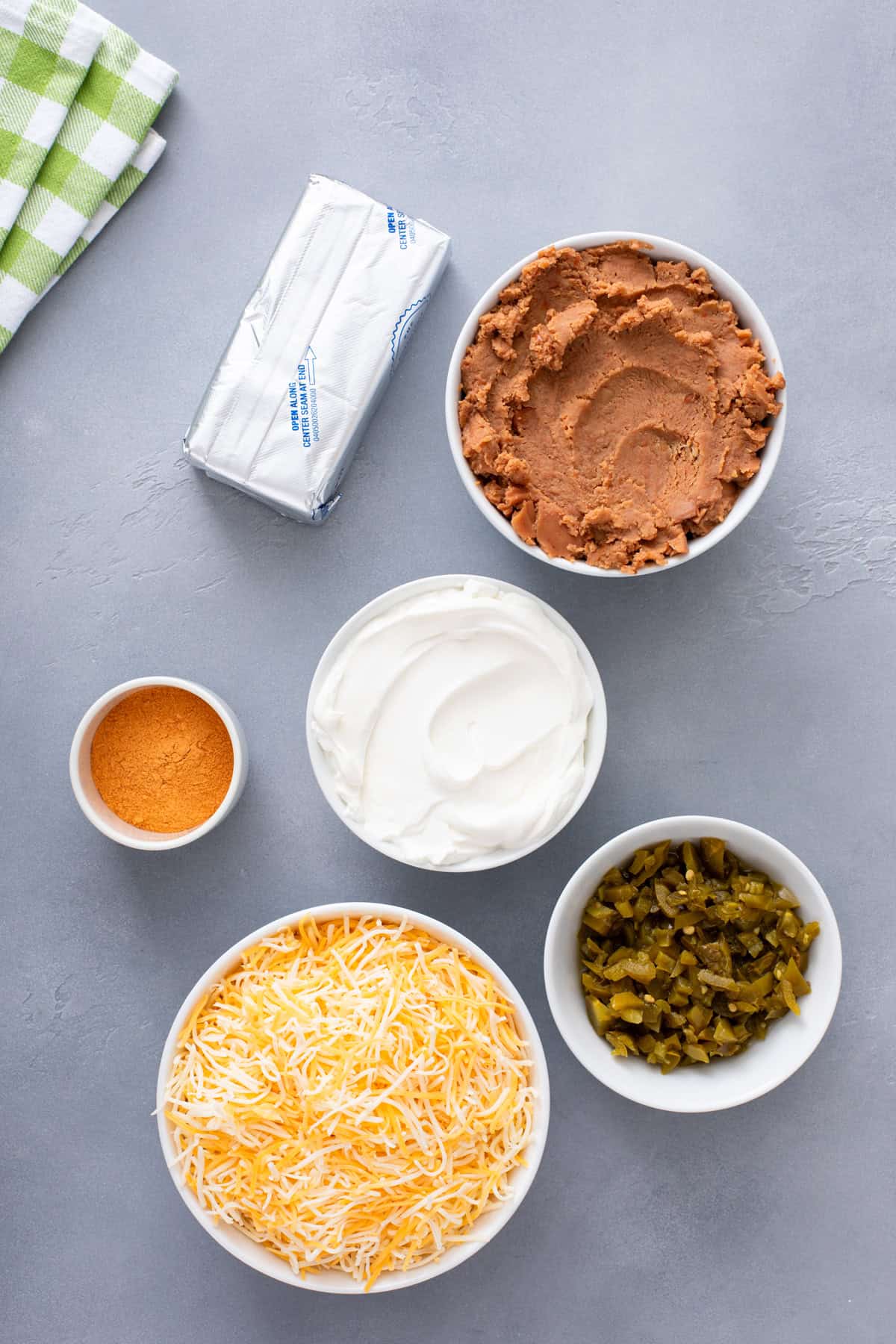 Ingredients for texas trash dip arranged on a countertop.