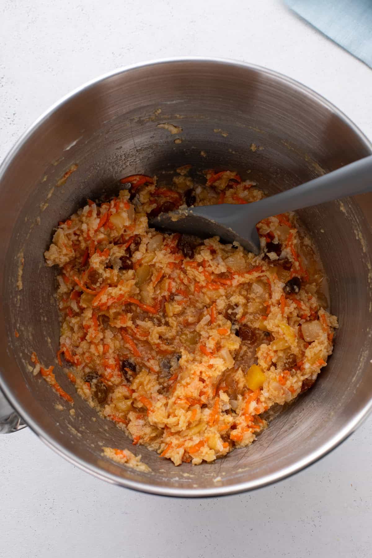 Wet ingredients for carrot cake cookies mixed together in a metal bowl.