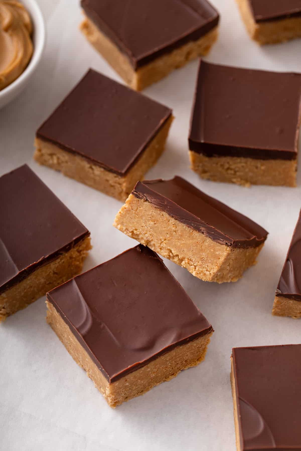 Squares of lunch lady peanut butter bars arranged on a countertop.