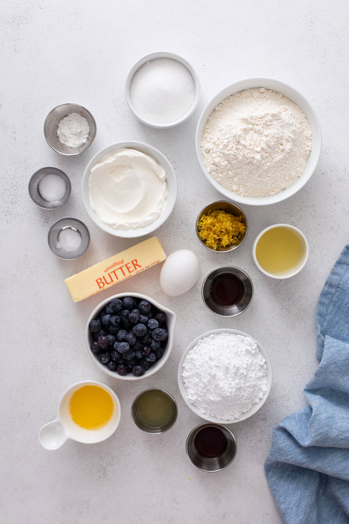 Ingredients for lemon blueberry scones arranged on a countertop.
