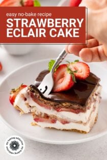 Fork cutting into the corner of a slice of eclair cake garnished with fresh strawberries. Text overlay includes recipe name.