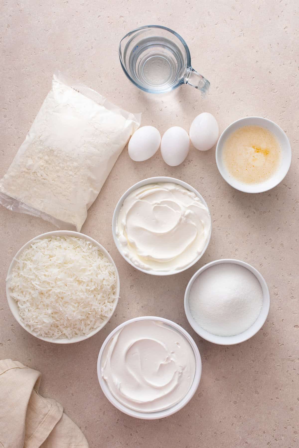 Ingredients for sour cream coconut cake arranged on a countertop.