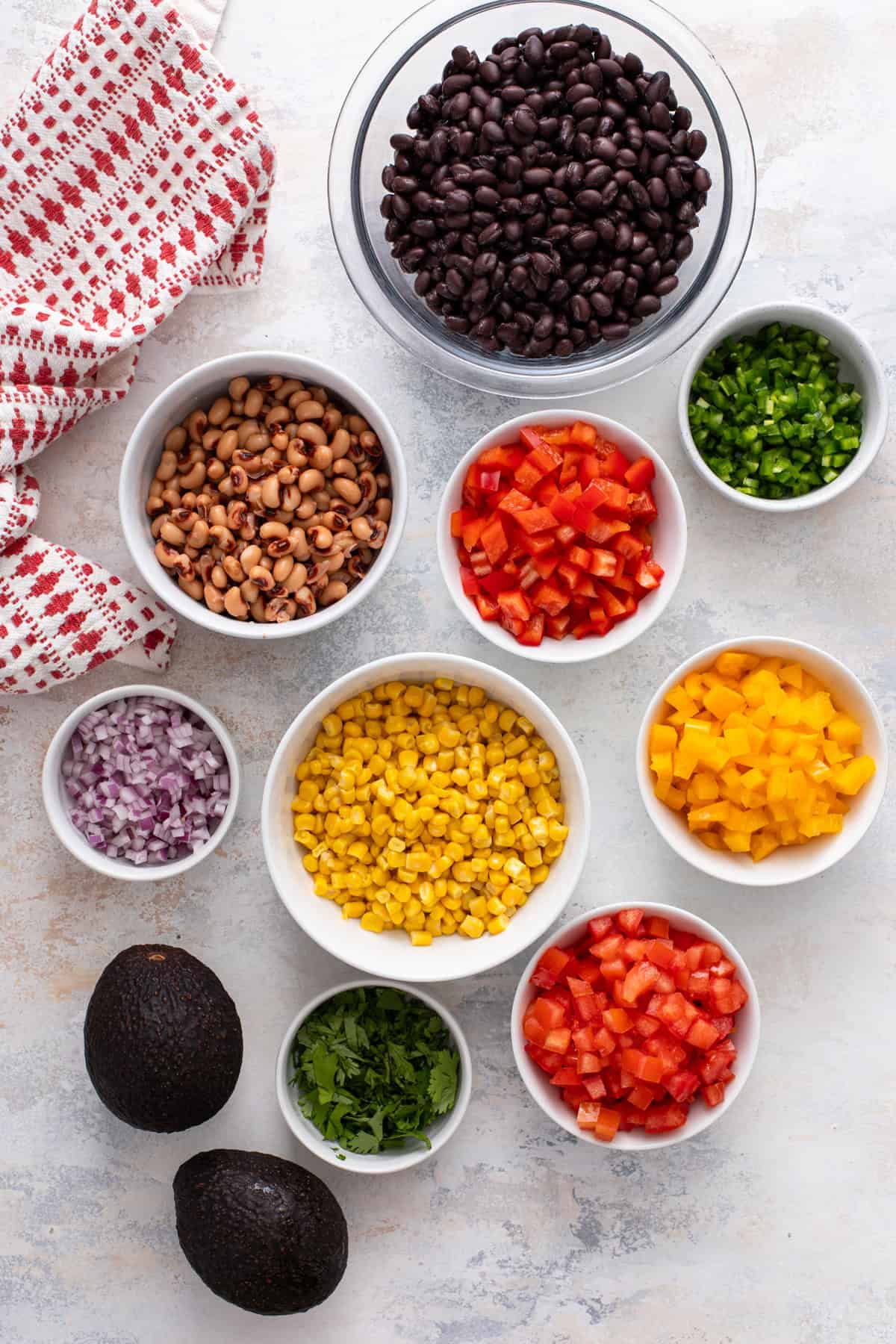 Ingredients for cowboy caviar arranged on a countertop.