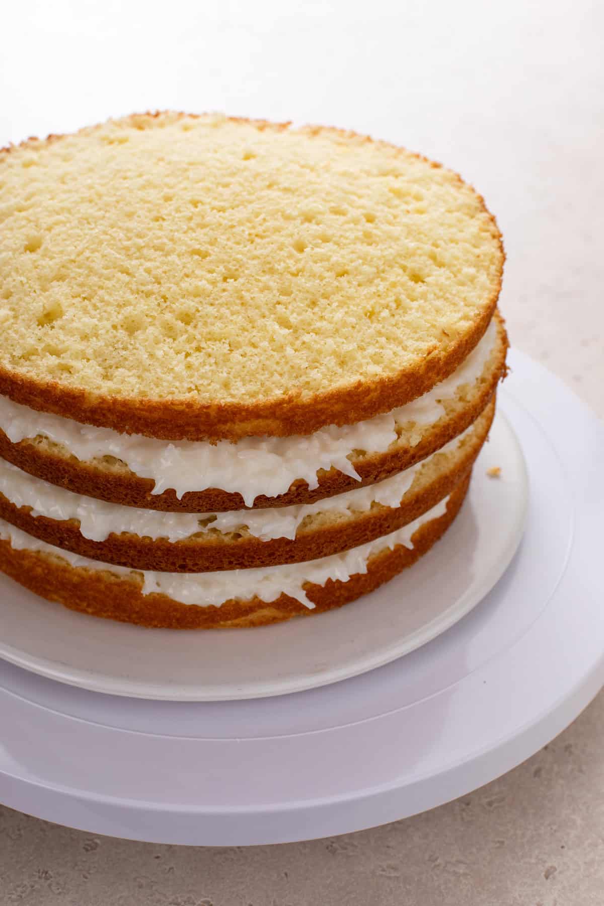 Four layers of butter cake with sour cream and coconut filling between each one.
