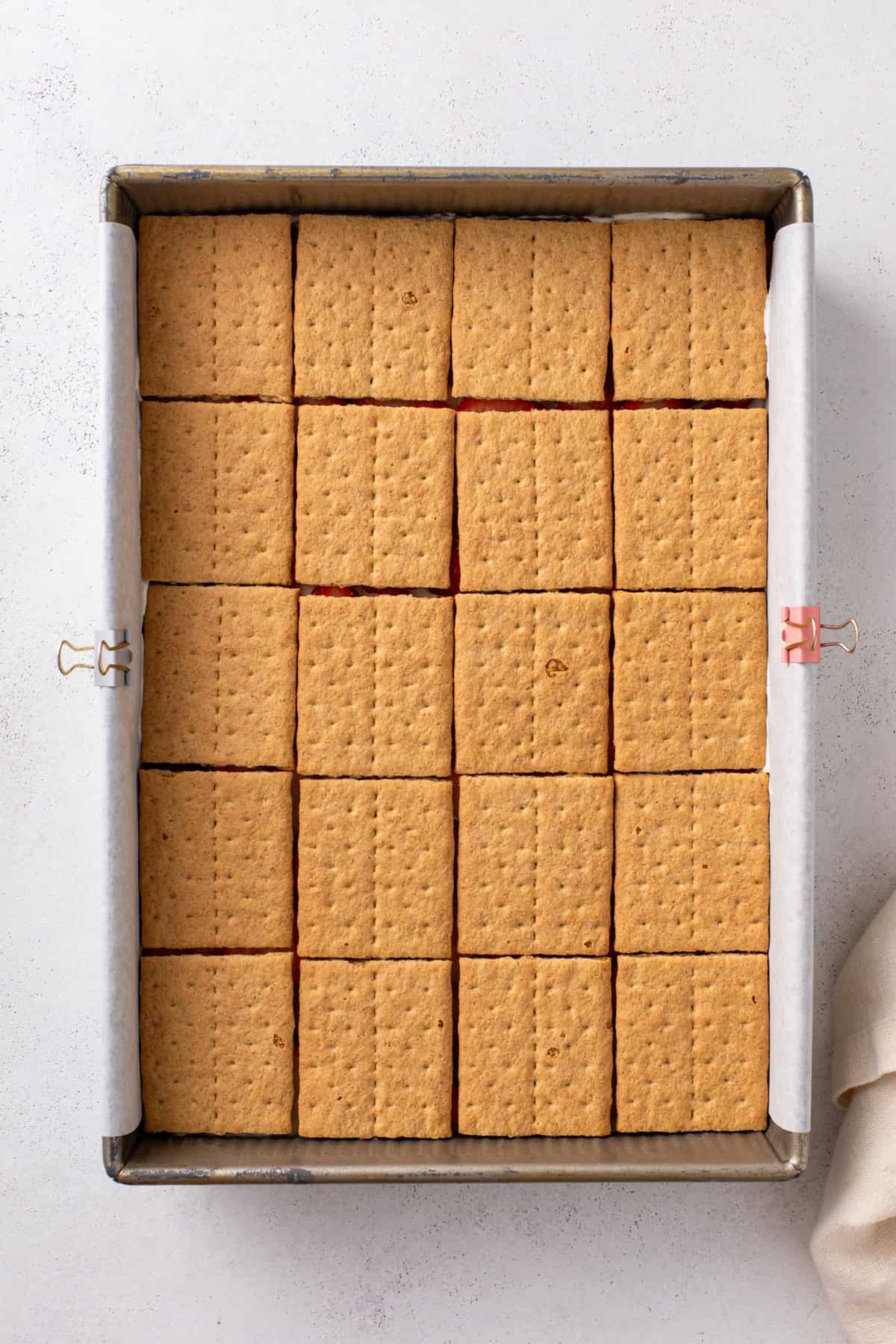 Layer of graham cracker squares arranged in a baking dish.