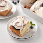 Blueberry sweet roll on a white plate.