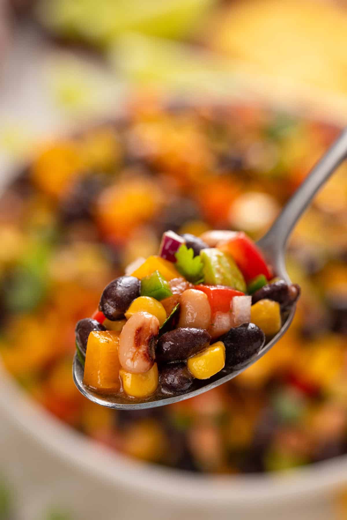 Spoon holding up a bite of cowboy caviar.