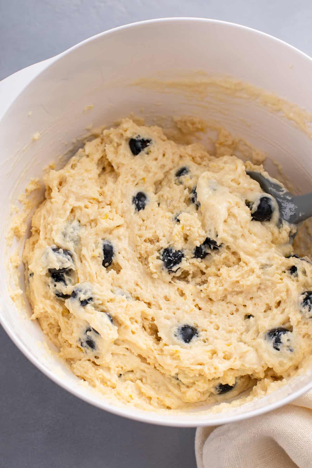 Lemon blueberry muffin batter in a white bowl.