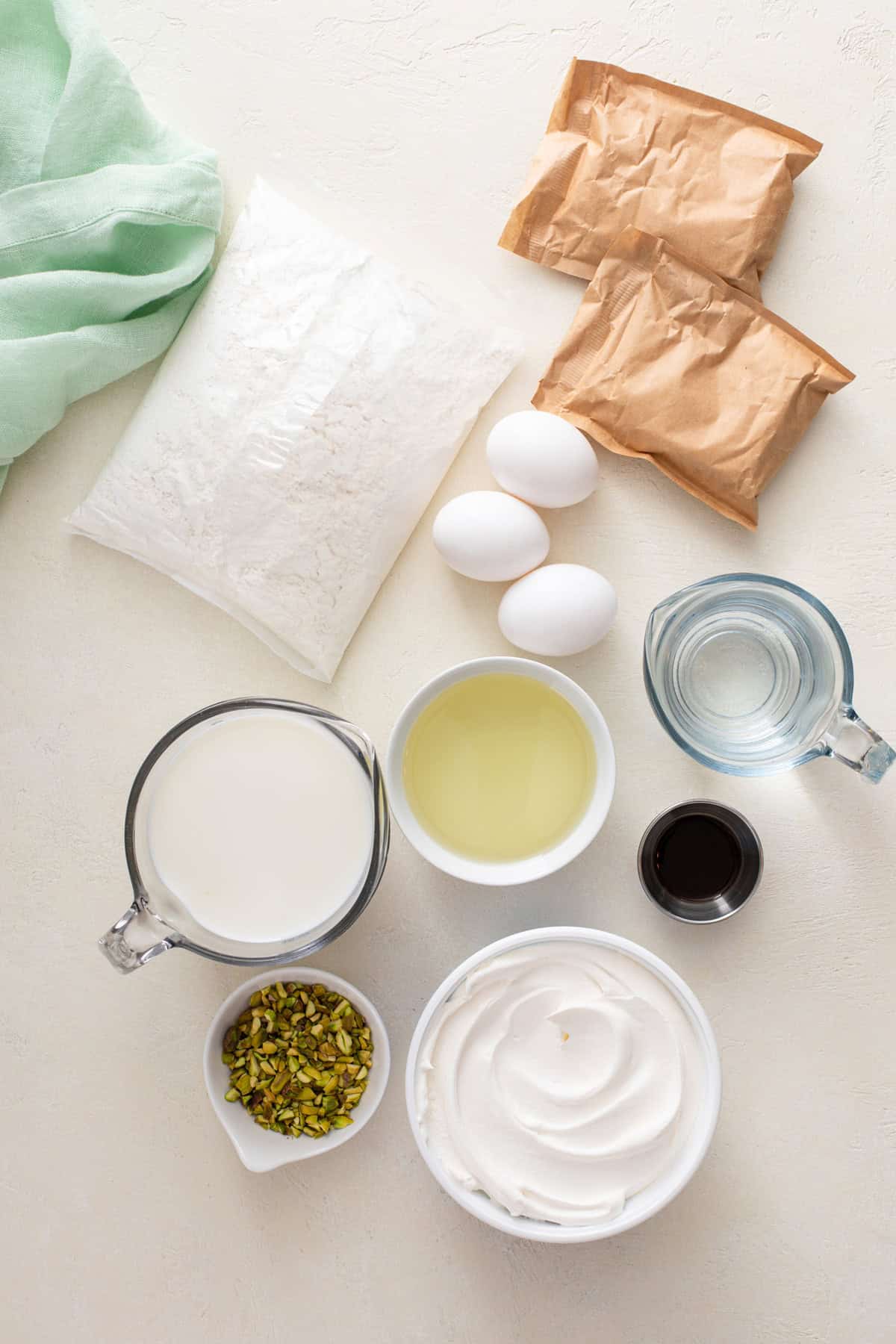 Ingredients for pistachio poke cake arranged on a countertop.