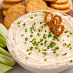 Pretzels in a bowl of ranch beer cheese dip.