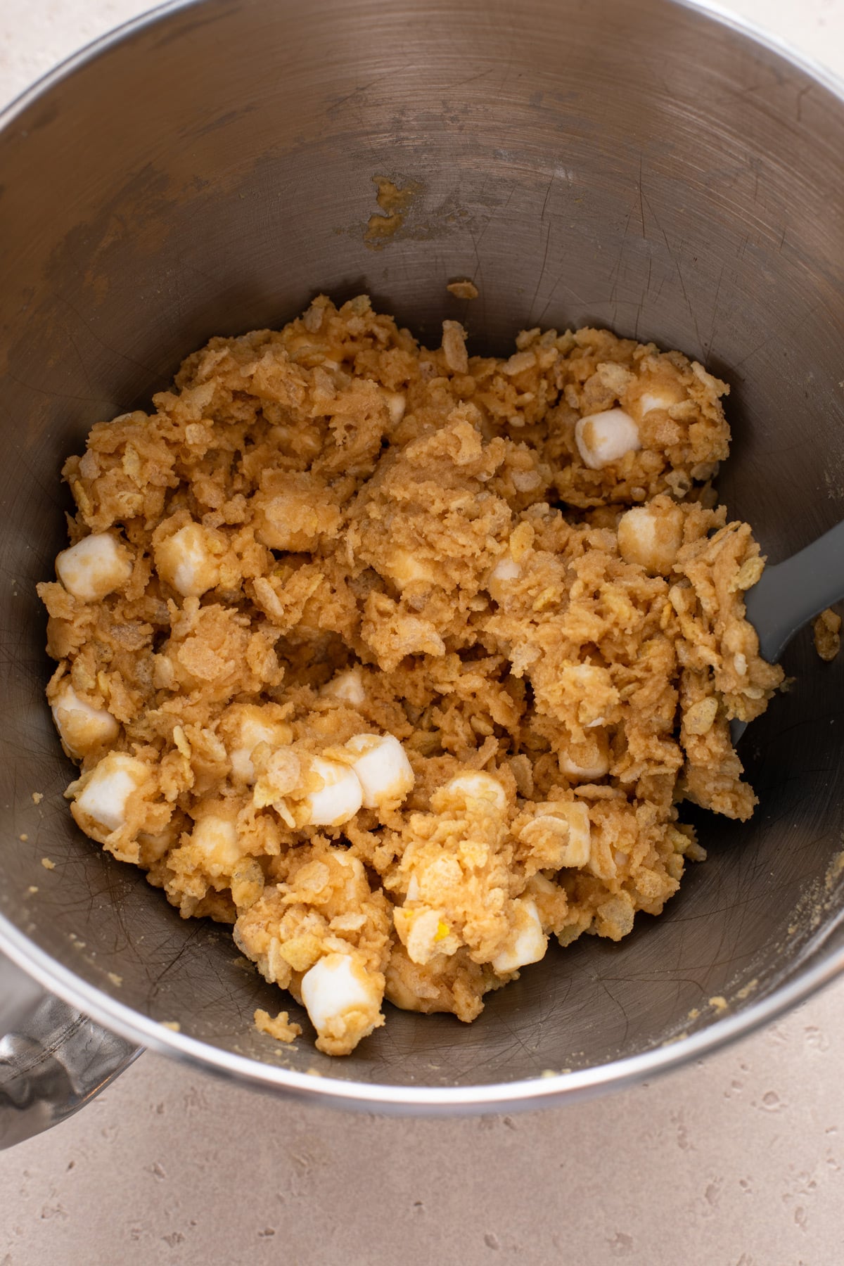 Dough for rice krispie cookies mixed in the bowl of stand mixer.