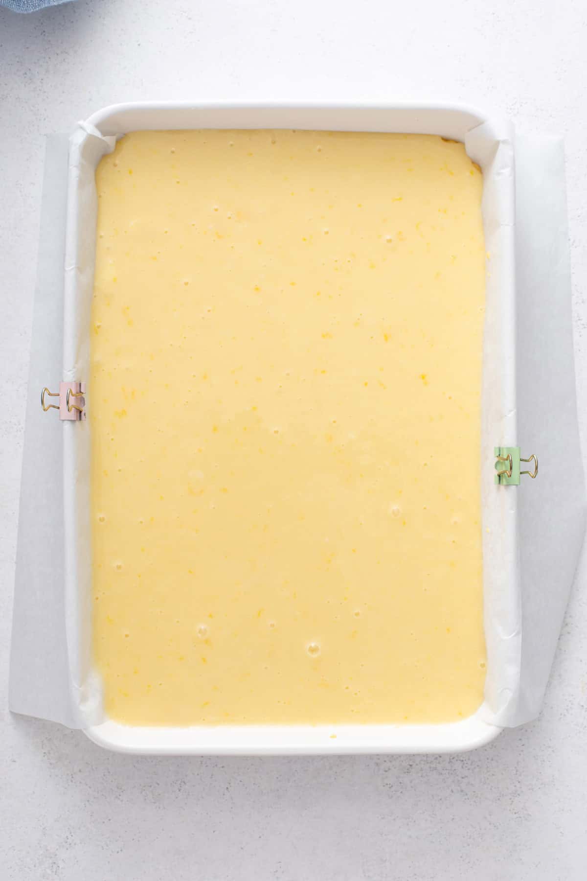 Lemon gooey butter cake assembled in a baking pan, ready to go in the oven.