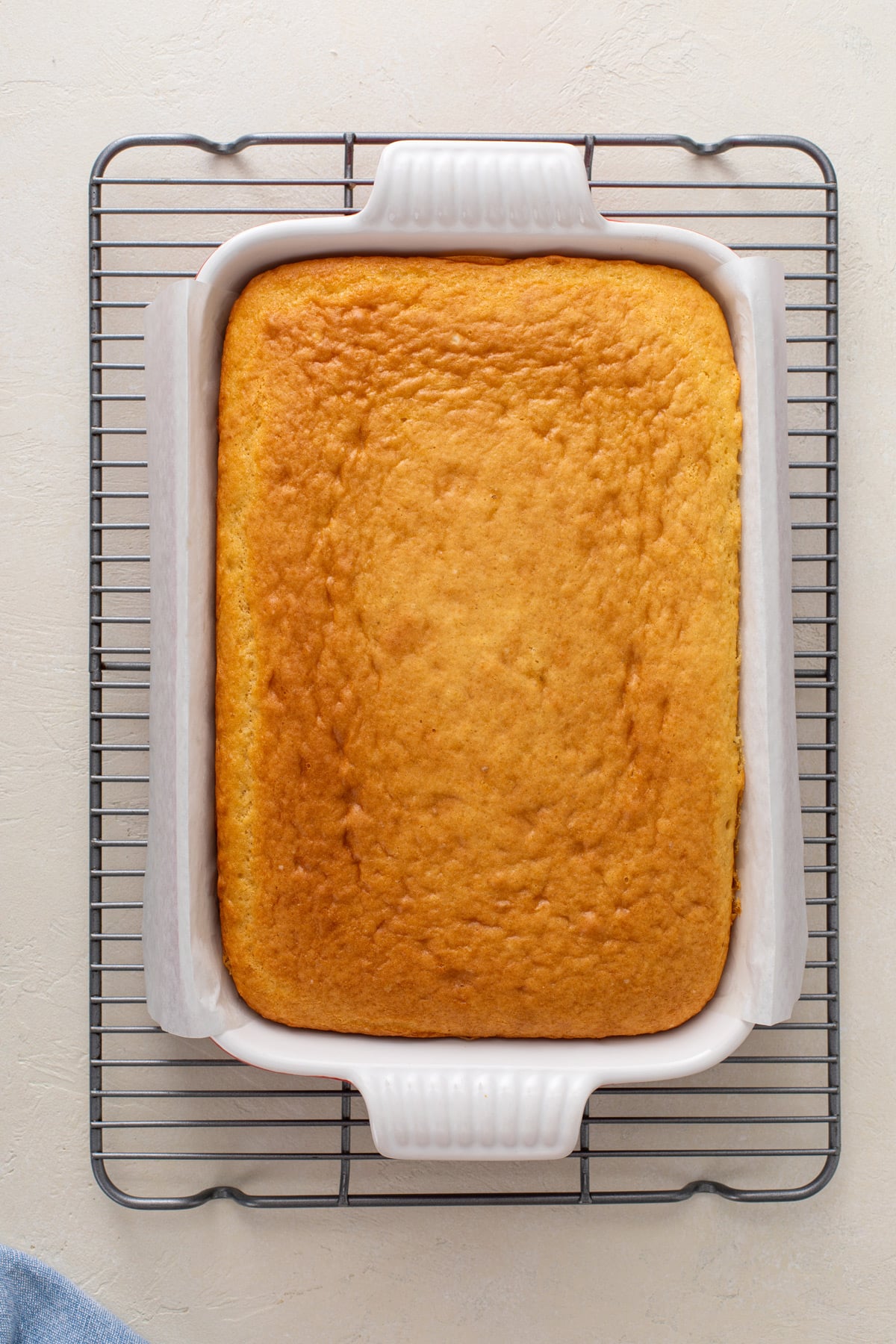 Easy yellow sheet cake cooling on a wire rack.