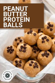 Peanut butter protein balls arranged in a parchment-lined glass container. Text overlay includes recipe name.