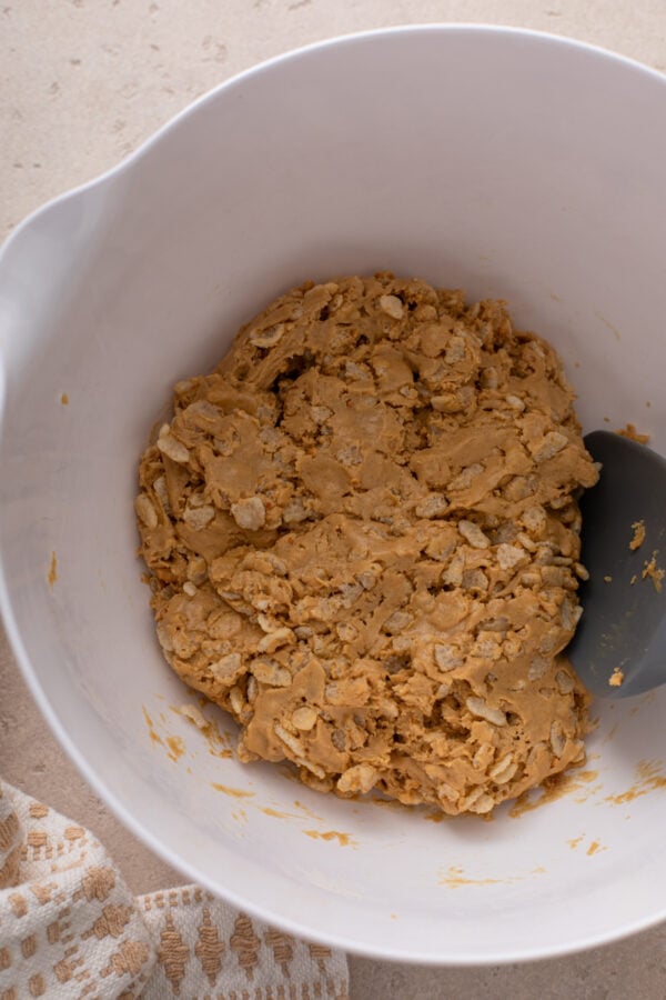 Dough for peanut butter protein balls mixed in a white bowl.