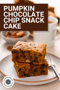 Two slices of pumpkin chocolate chip snack cake stacked on a plate in front of a cup of coffee. Text overlay includes recipe name.