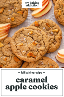 Close up view of caramel apple cookies scattered on parchment paper amongst fresh apple slices. Text overlay includes recipe name.